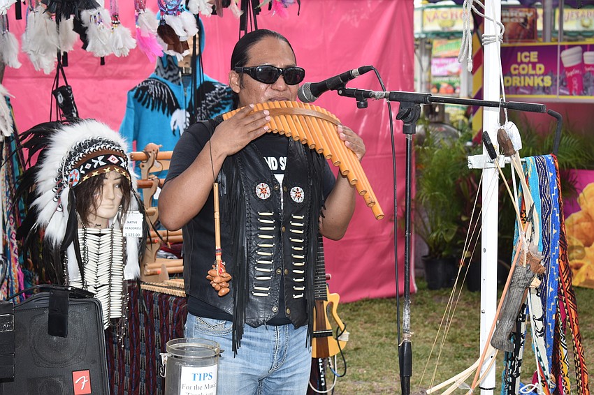 Native Wind's Inti Tambaco plays the pan flute for passersby.