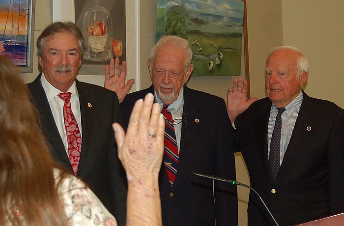 Town Clerk Trish Shinkle administers the oath of office to commissioners Mike Haycock, George Spoll and Jack Daly.