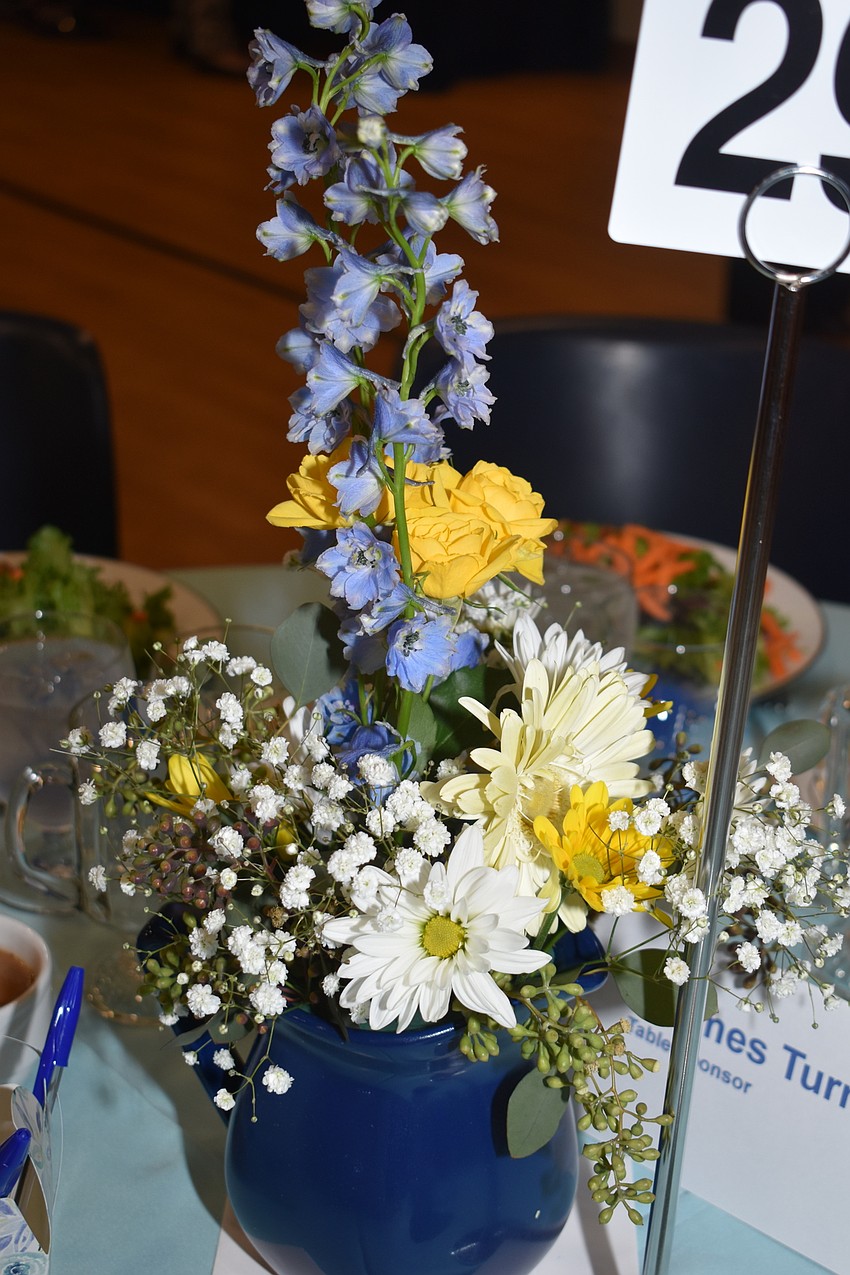 The floral arrangement brought life to the tables.