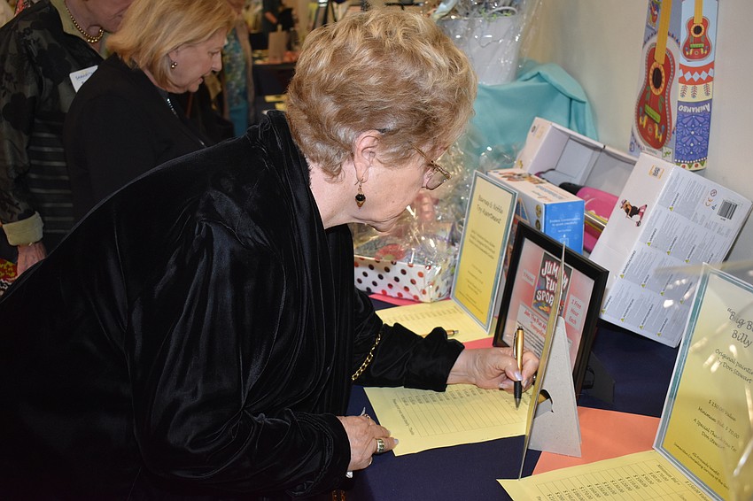 Sue Simpson bids on an item in the silent auction.