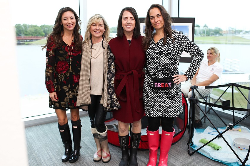 Donna Koffman, Tammy Karp, Clara Reynardus de Villanueva and Melissa Morsli all wore their rainboots for the dreary day.