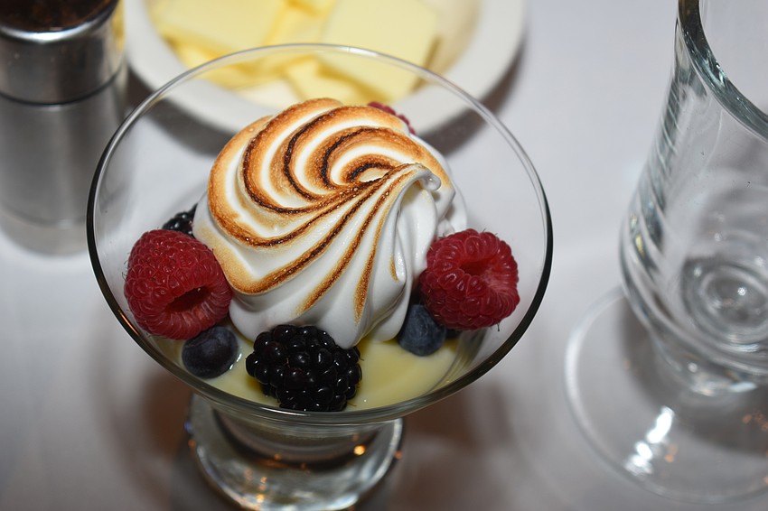 A dessert served included berries and a meringue swirl.