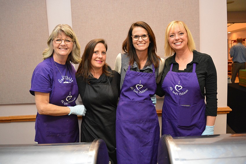 All God's Children teachers Janice Marmo, Jamie Cristllo, Crystal Fulk and Jennifer Butler dish out food for guests.