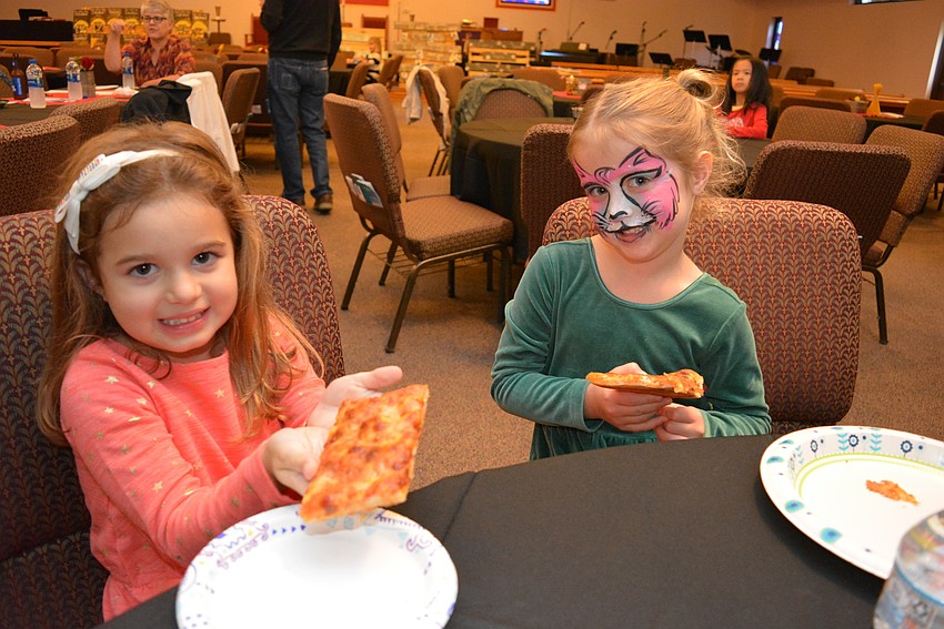 Claire Oliveira and her friend Clara Heuss feast on pizza.