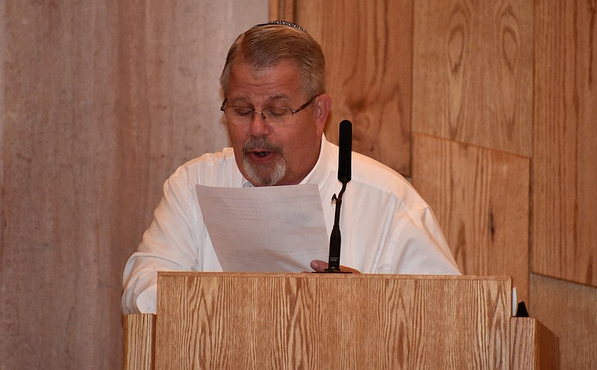 Rabbi Stephen Sniderman reads the beginning of the temple’s Purim skit.