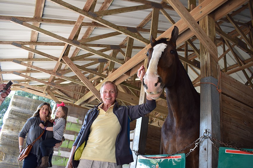 Don Wolk, of Country Club East, pets one of the horses.