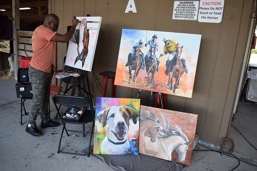 Tom Ruthz was painting while other attendees met the horses.