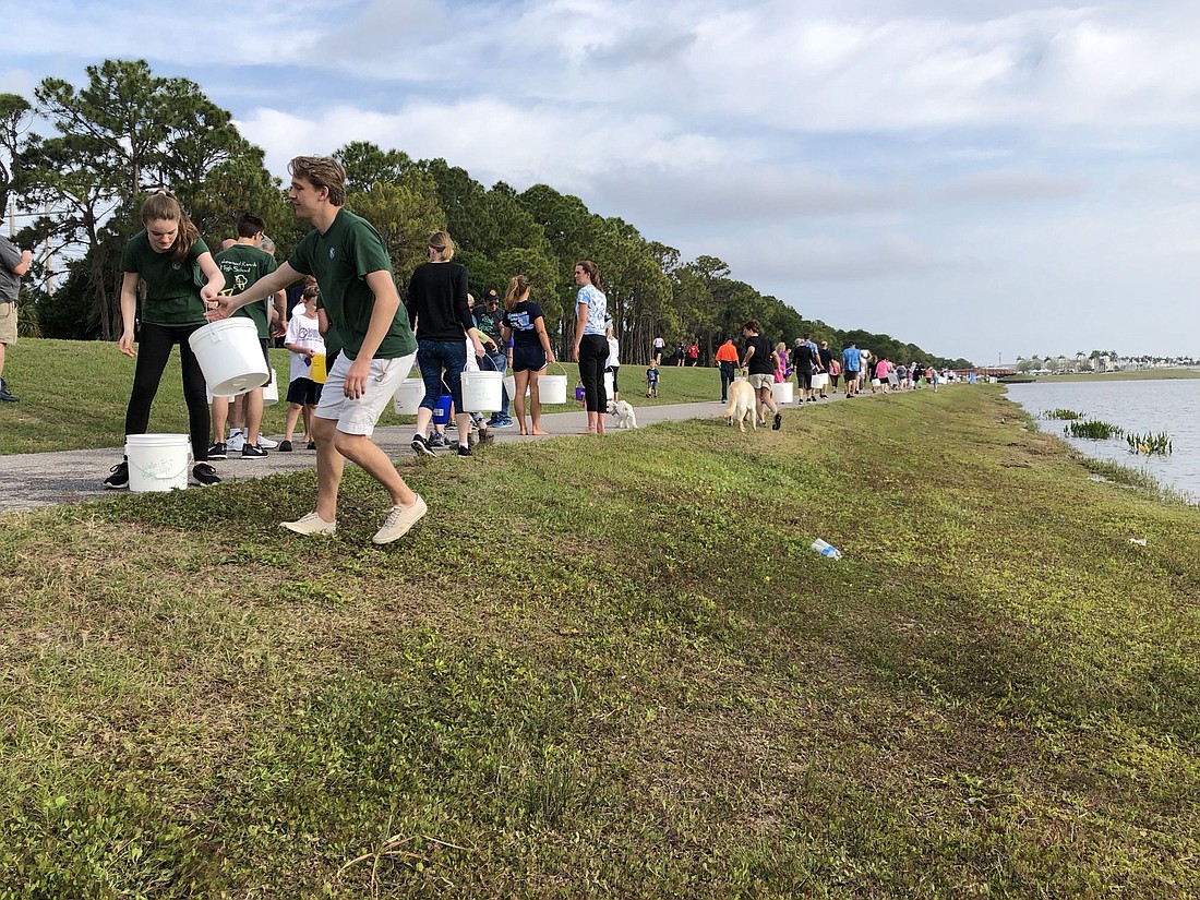 Participants at the 2018 Walk for Water carry their buckets.