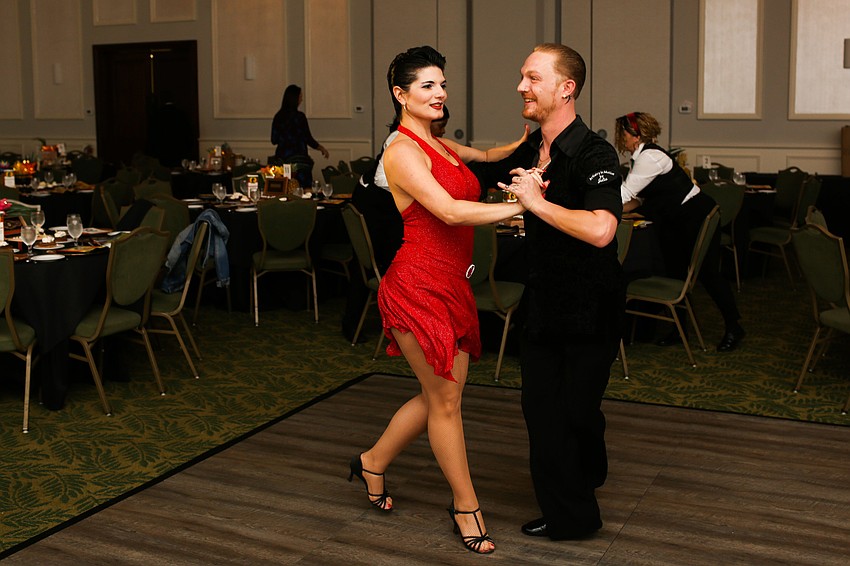 Sarah Glass and Joshua David salsa dance for guests.