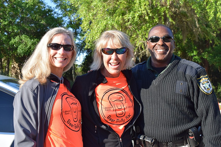 Race volunteers Mary Quinn and Vickie Barth helped encourage and guide racers with the help of sheriff deputy Damon Ackerman.