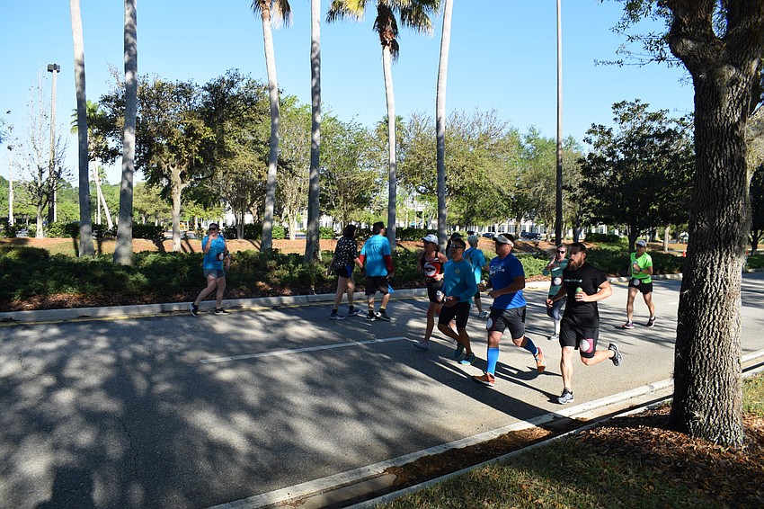 While slower participants stuck on one side of the road, faster runners looped back for the last stretch of the race on the other side.