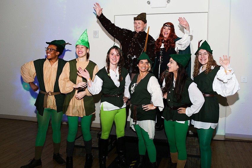 President Larry and Pat Thompson wave to the crowd after making their grand entrance.