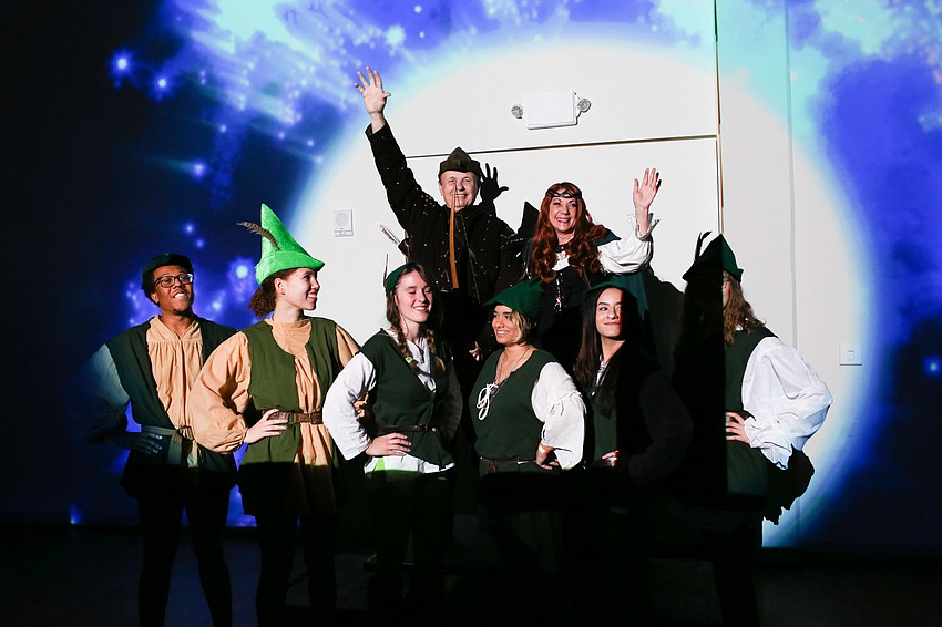 President Larry and Pat Thompson wave to the crowd after making their grand entrance.