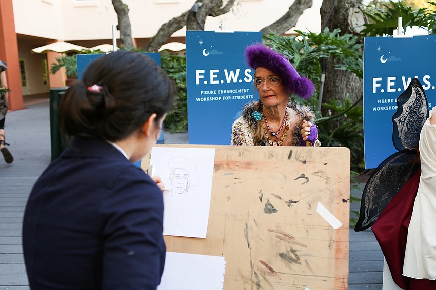 Jessica Dirkes gets her portrait drawn.