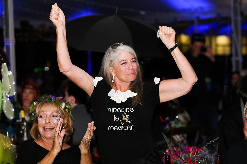 Co-Chair Marci Klein jumps up as her group wins best group.