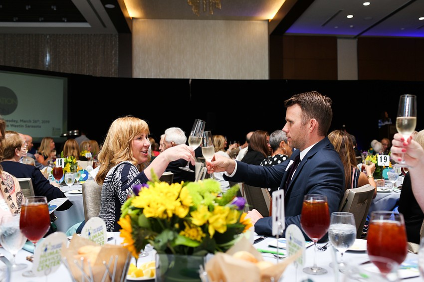 Heather Mackey and Michael Johnson toast.
