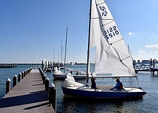 Competitors prepare to launch their vessel into the bay.