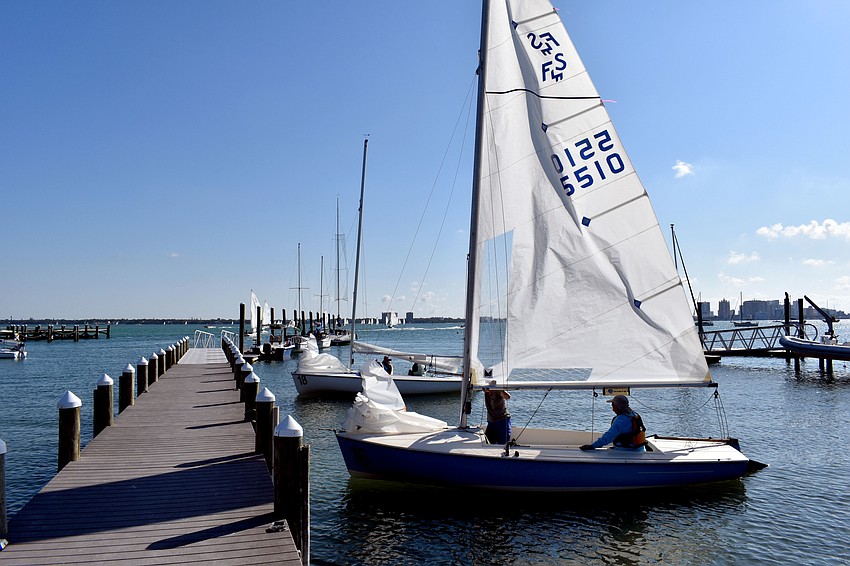 Competitors prepare to launch their vessel into the bay.