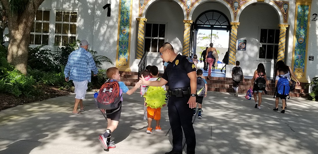 SCSPD Sgt. Steve Kim greets students at Bay Haven & School of Basics Plus. Photo courtesy of Sarasota County Schools.
