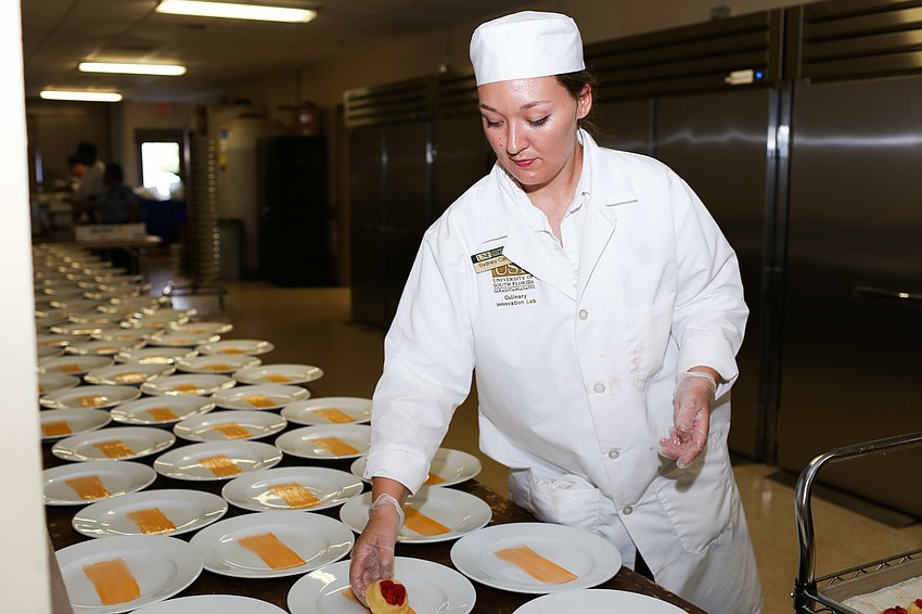 Sydney Camp places the strawberry shortcake dessert on the plate.