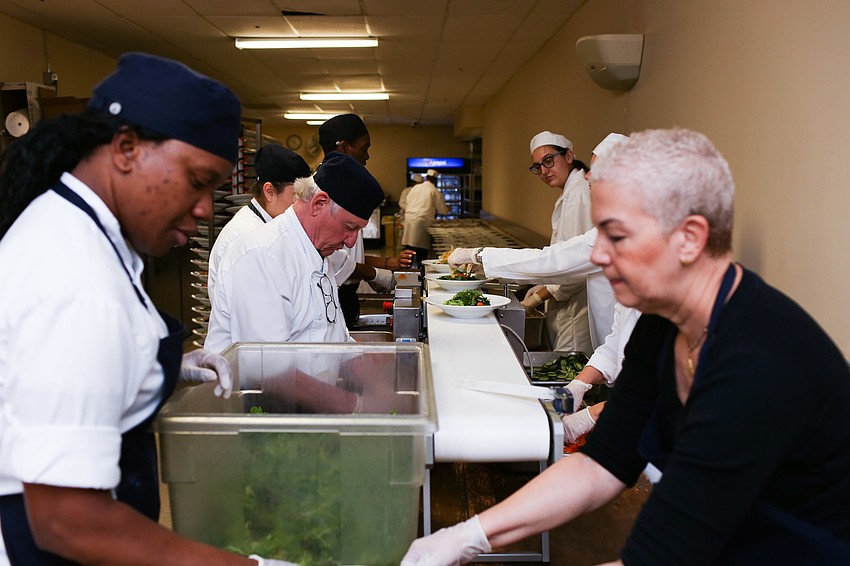 A conveyor belt helped the salad assembly line move along.