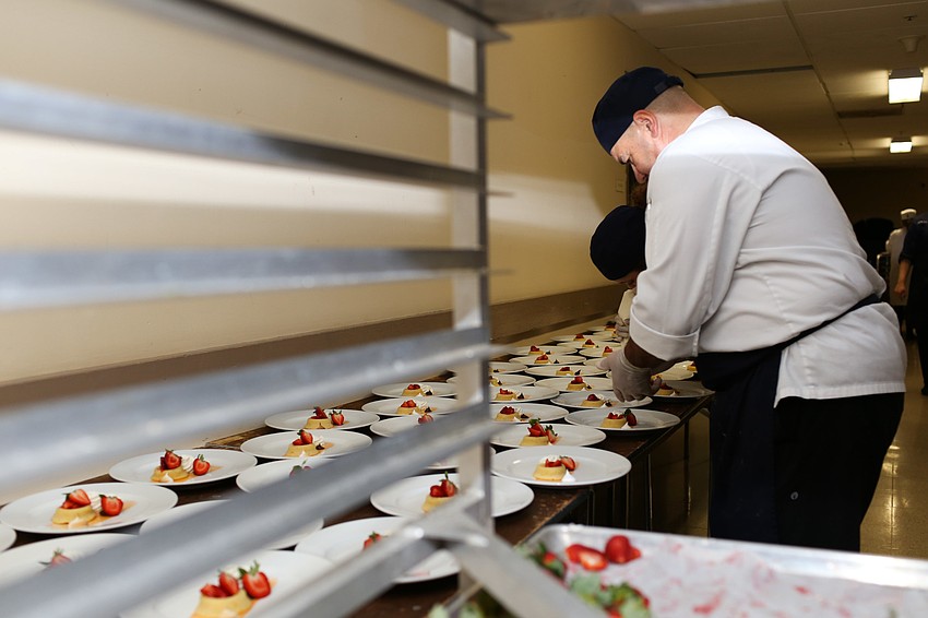 Pastry chef Karlheinz Schoenberger helps the students with the desserts.