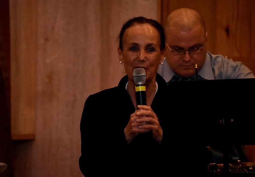 Ann Stephenson Moe, the conductor and artistic director for the choir, welcomes the crowd.