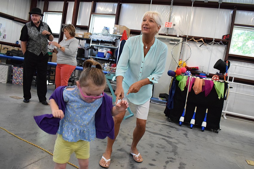 Suncoast Charities for Children Executive Director Lucy Nicandri dances with Preslie Hutchinson.