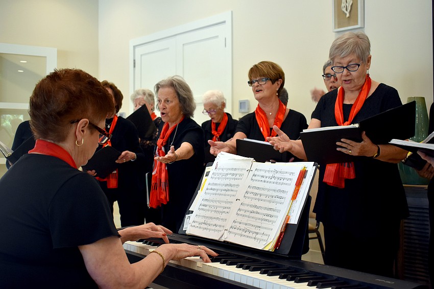 Director Carol Whitfield performs from behind the keyboard.