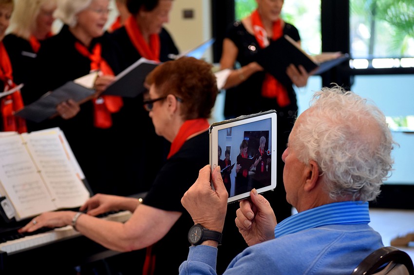 A member of the audience records the performance.