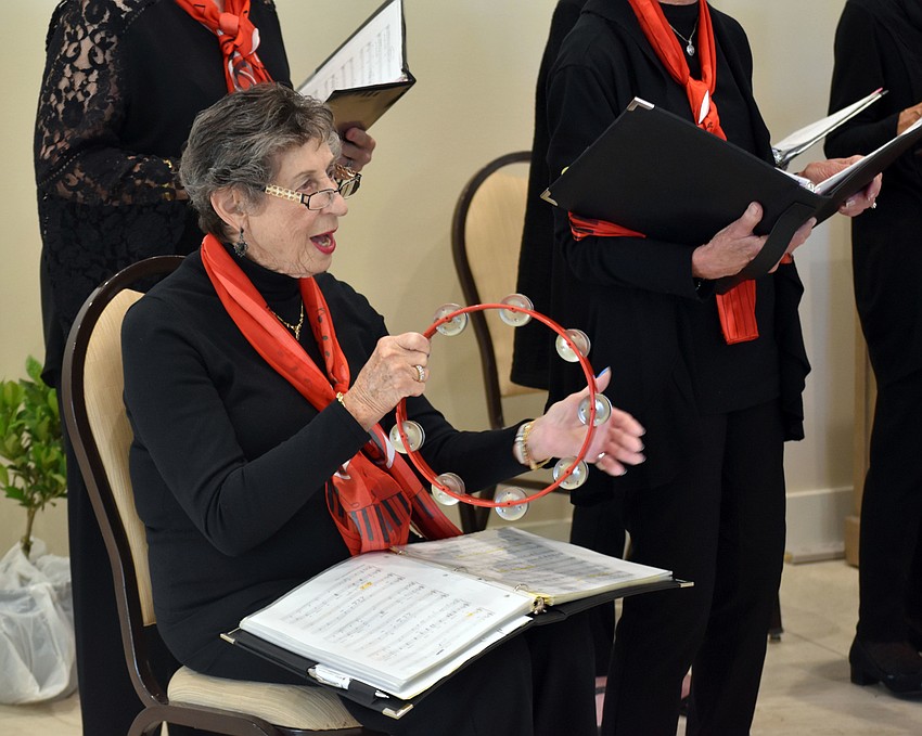Barcy Grauer plays the tambourine during 