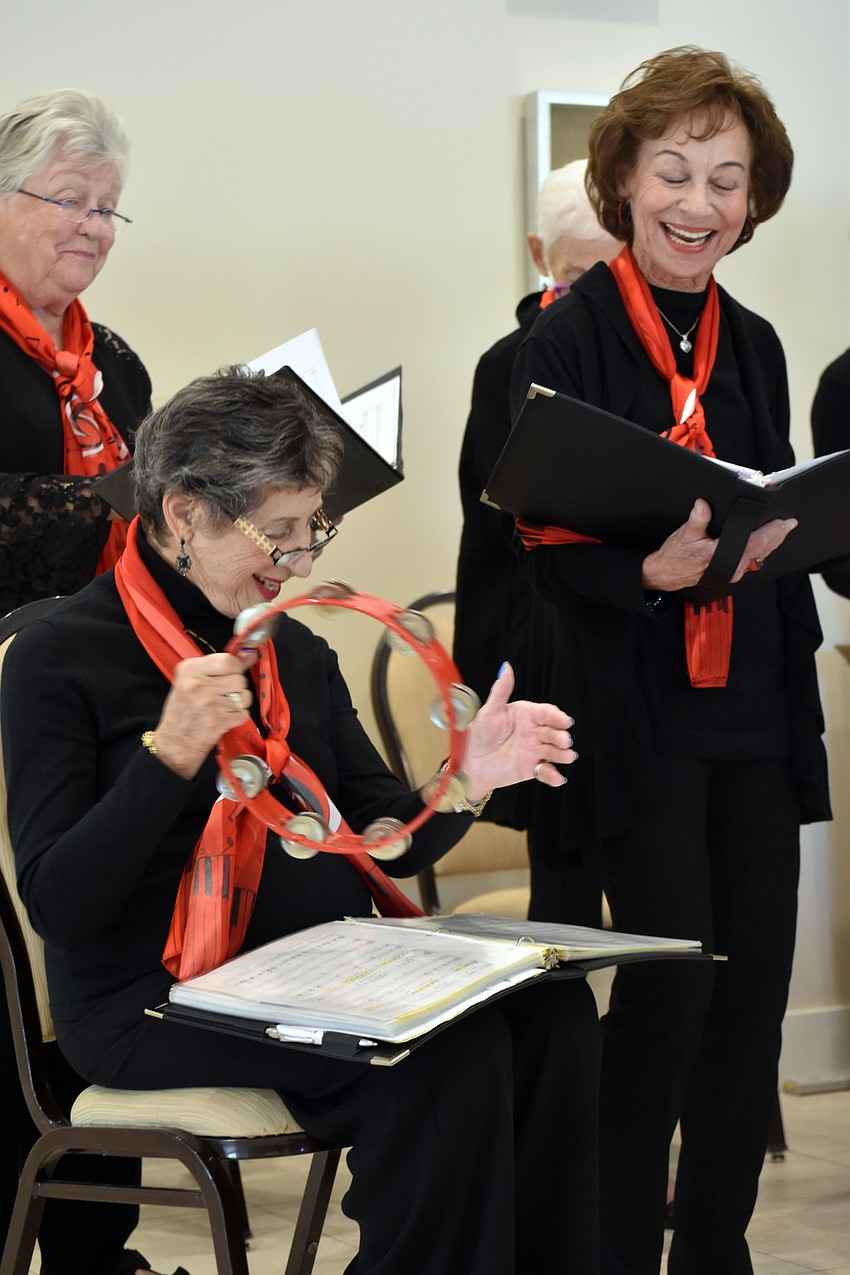 Members of the chorus can't help but smile as they perform.