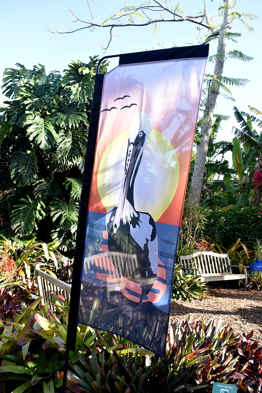 Artwork by students at the Sarasota School of Arts and Sciences flew in the wind at the event entrance.