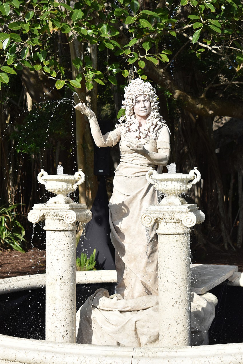 A woman dressed as a fountain statue blends in until she starts dancing.