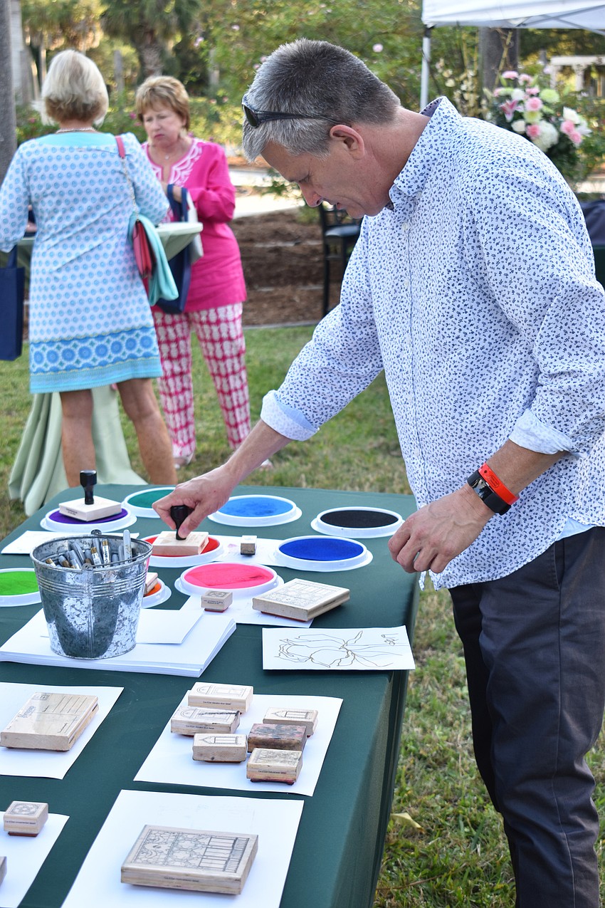 Steve Doe creates a floral card at the stamping station.