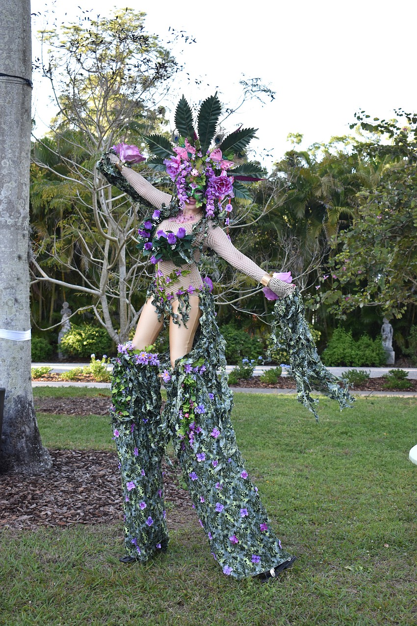 Lyn Sky took photos with guests dressed as a Mother Nature-inspired stilt walker.