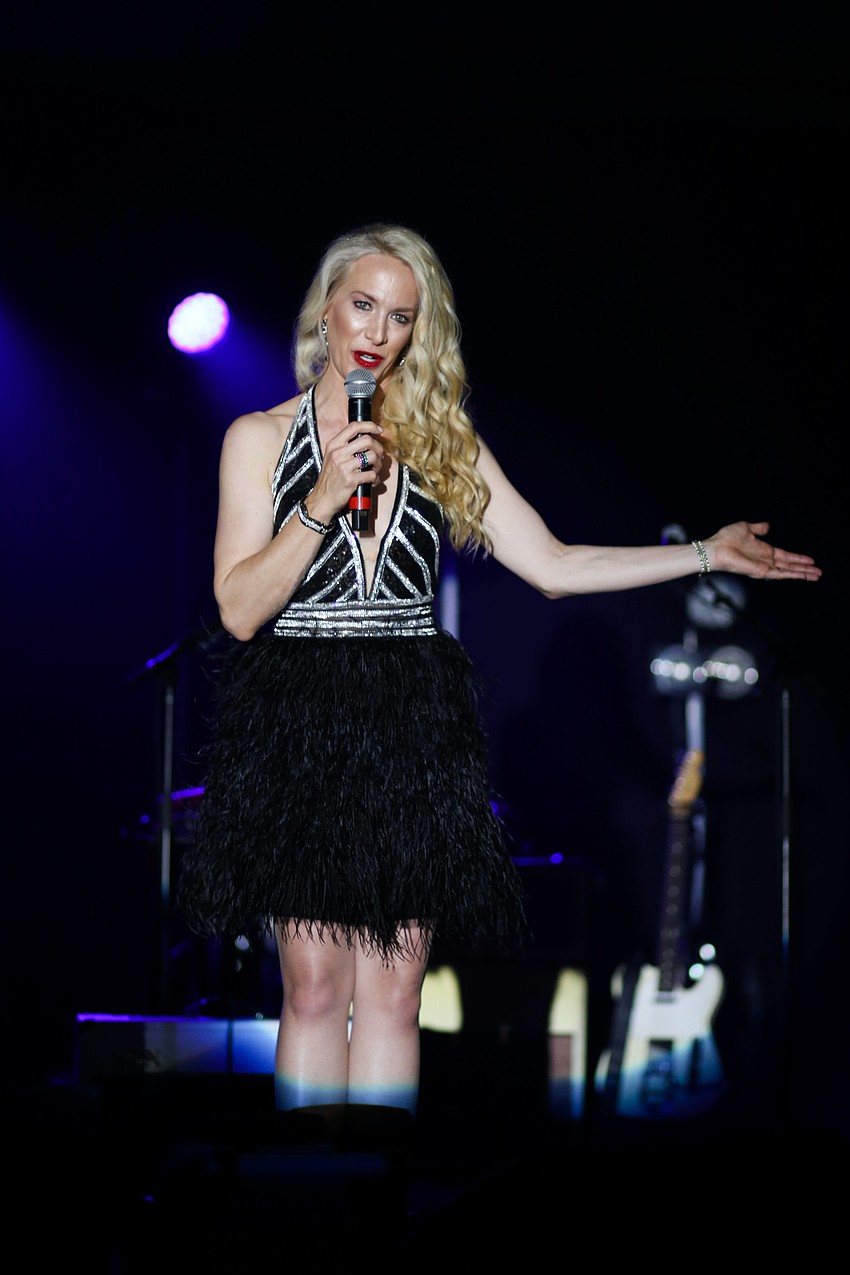 Chairwoman Ariane Dart introduces Kesha to the stage.