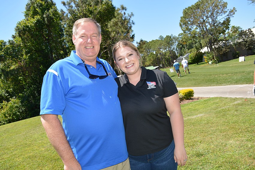 Valrico's Tom Hier and his daughter Brittany Peterson volunteer at a hole. Peterson and her husband, Stephen, a veteran, will benefit from next year's golf tournament.