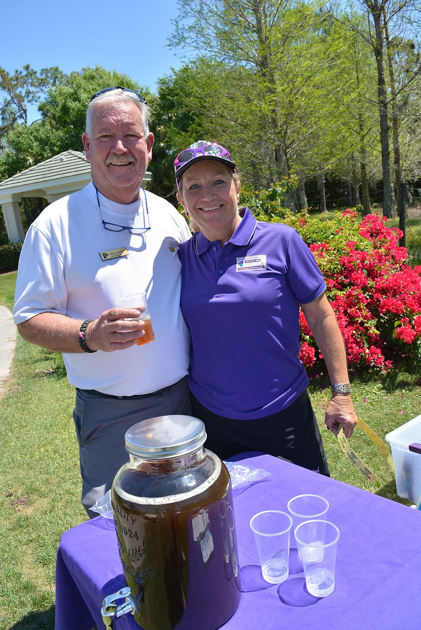 Rosedale Golf and Country Club golf course superintendent Doug Cunefare tries some of the peach whiskey iced tea provided by sponsor Dee Donegan, of Designed Finishes LLC. Donegan is Rosedale's women's golf champion.