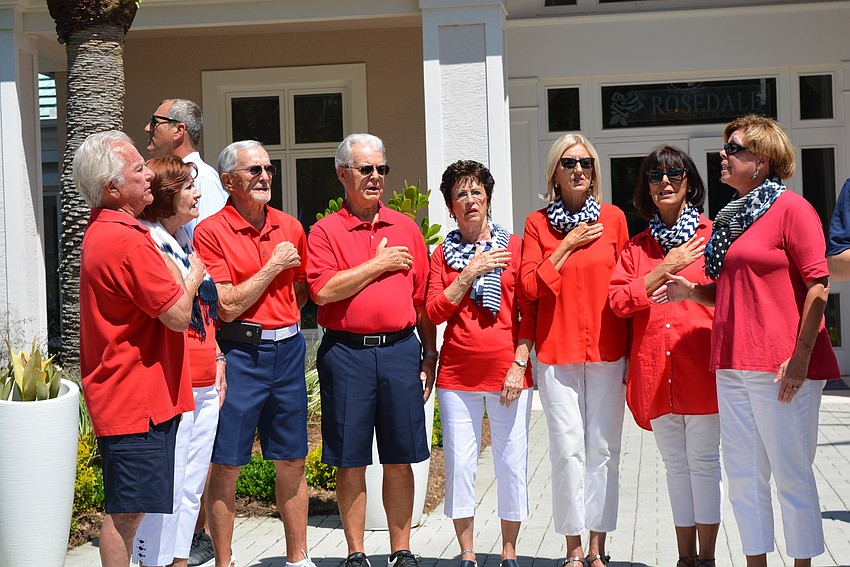 Residents of Rosedale lead the crowd in the national anthem.