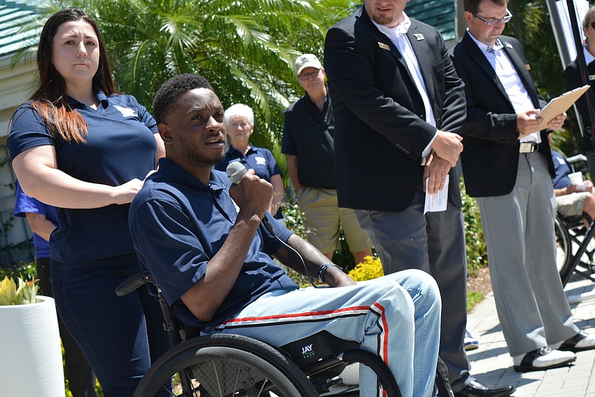 Veteran Michael Monthervil, with his girlfriend Ashley Nickles (behind) thanks participants for raising funds for his home, to be built in Wimauma.