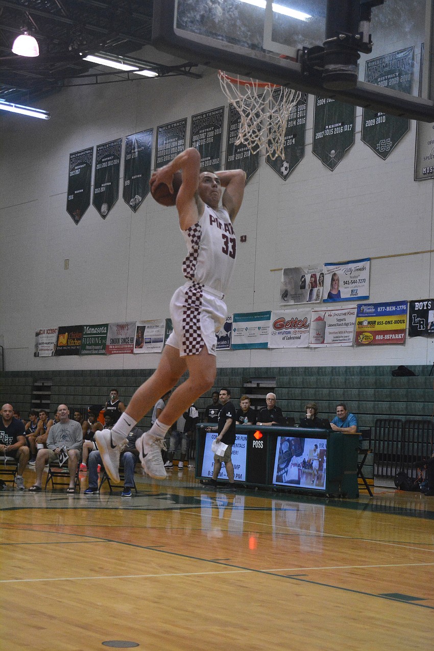 Braden River's Chase Owen soars during the dunk contest.