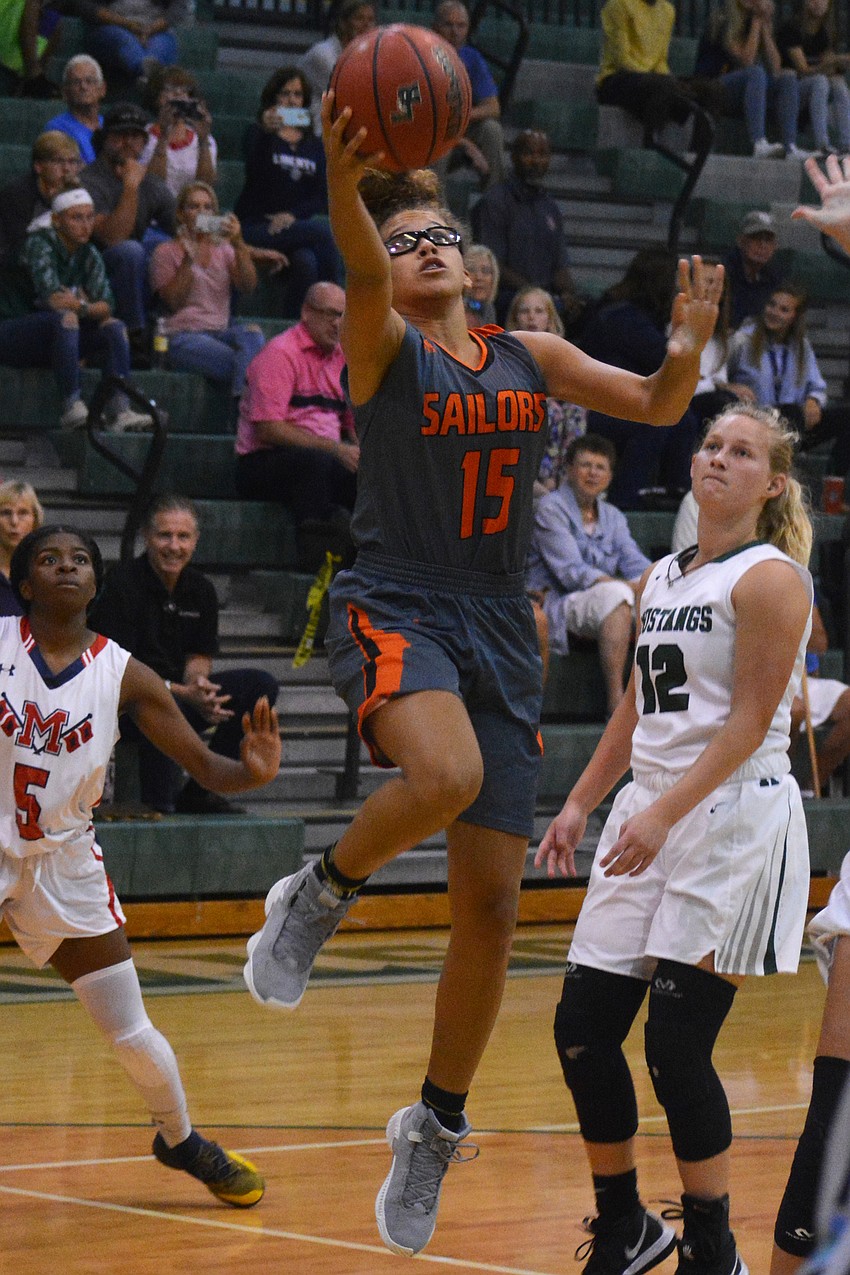 Sarasota's Kelly Brown sneaks through the defense for a layup.