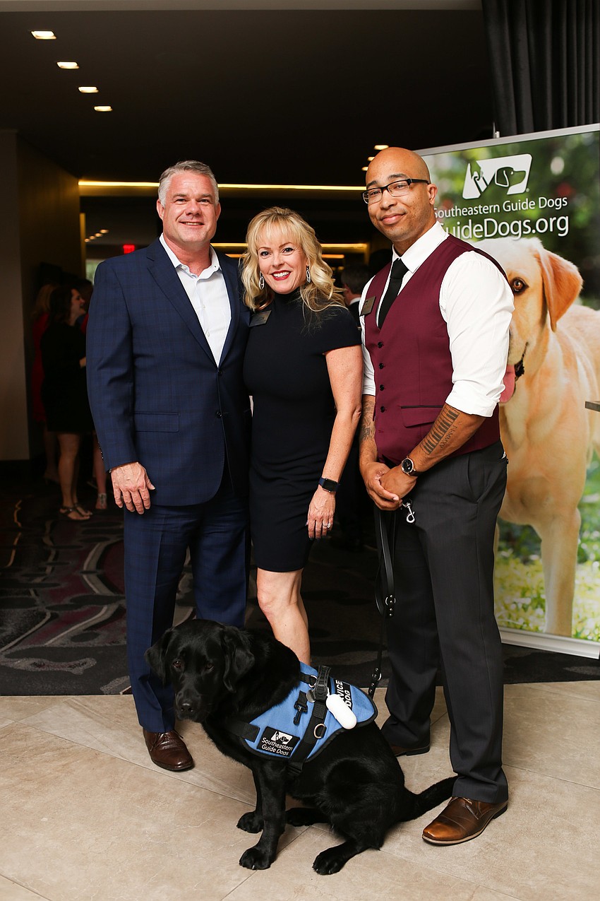 Co-Chairs Jason Hughes and Susan Malloy Jones with Sean Brown and his service dog Pella.