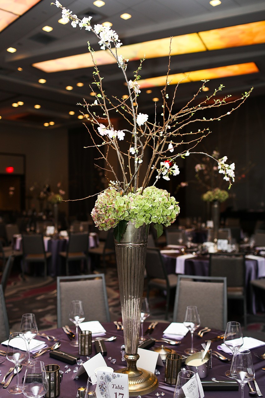 The centerpieces stood tall above the tables.
