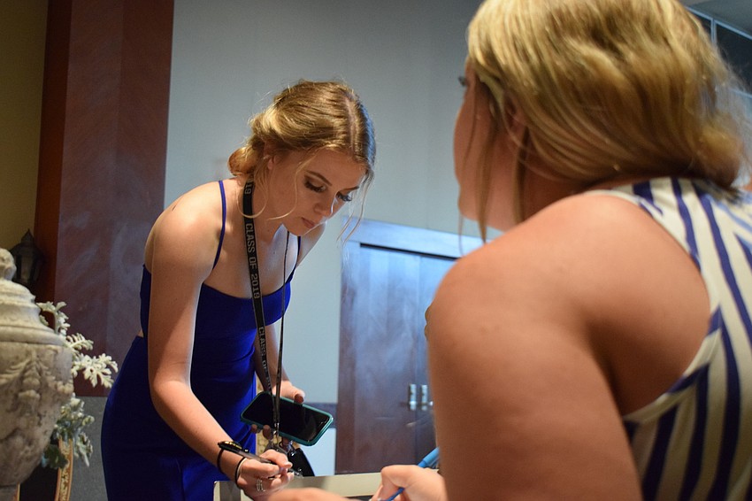 Senior Brianna Martin stopped at a table to vote for the Prom Queen and King.