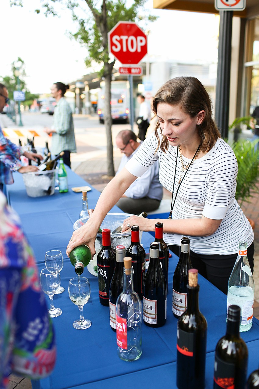 Amanda Pomp pours wine from Wagner Family of Wine.