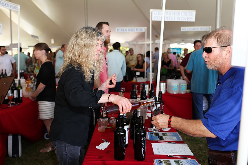 Shanti Montegomery pours Bruce Heiman a glass of wine.