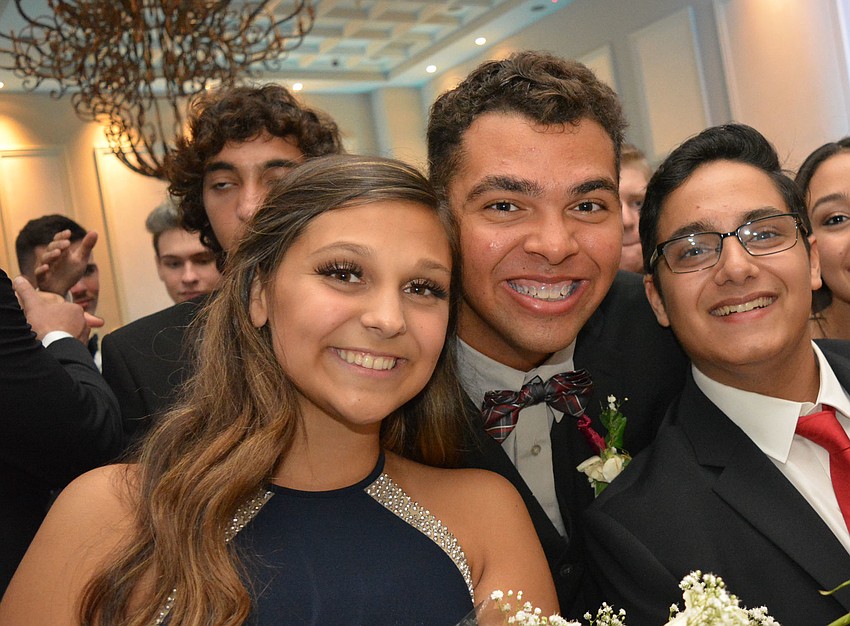 Gabby Griffin, Nathan Thomas and Ahmad Ibsais watch their friends, prom queen Jenna Mennes and her boyfriend Nick Anderson, dance to 