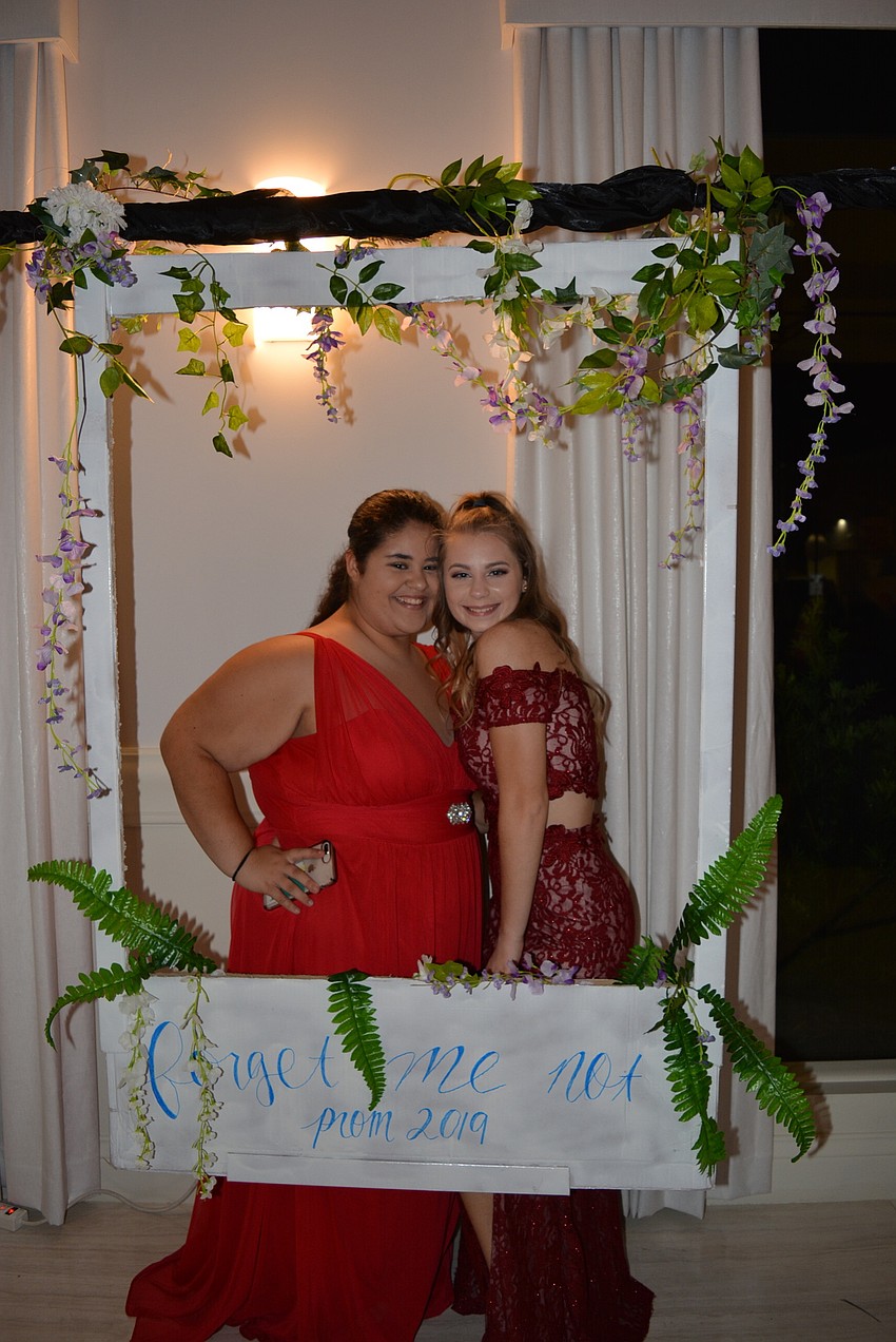 Juniors Irimia and Alexis Brackett pose in a frame created for the night's 